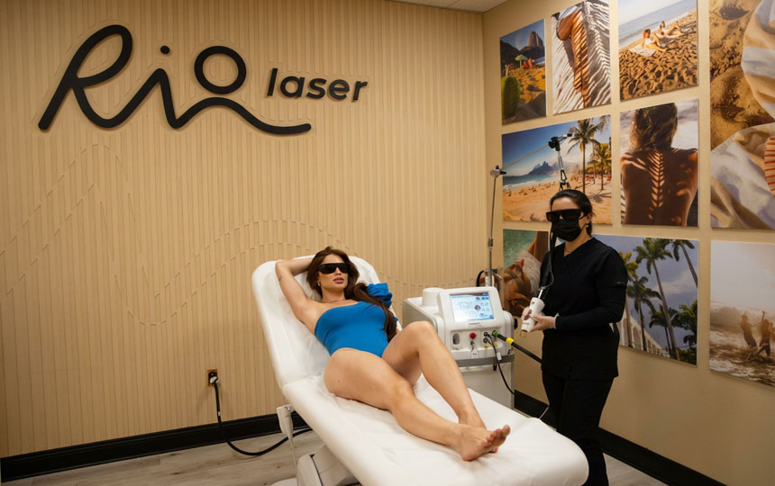 Client receiving laser hair removal treatment at Riolaser Orlando, lying on a treatment bed while technician applies laser to underarms. Comfortable, professional clinic environment.