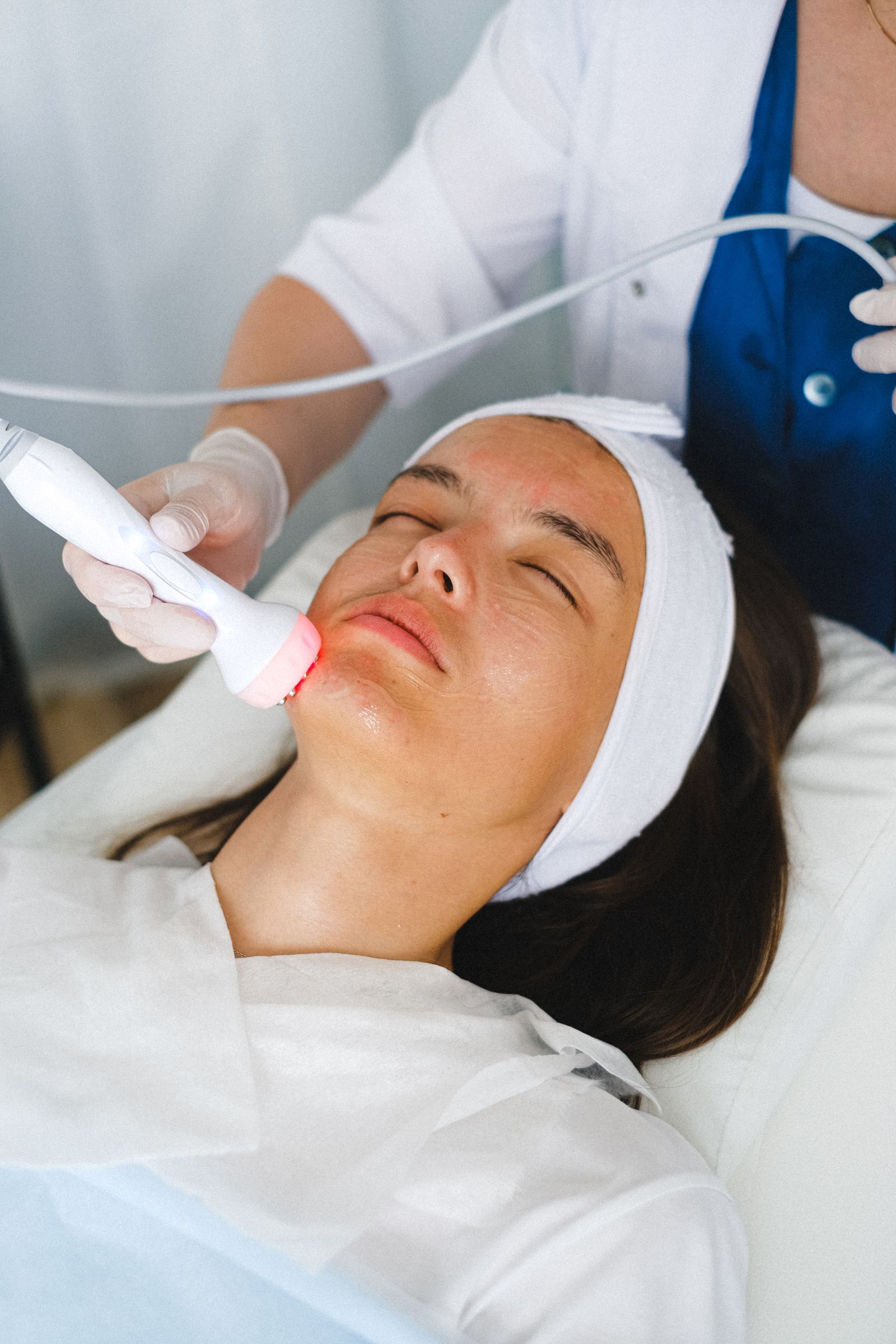 Client receiving a professional clinical skin treatment in a clean spa setting