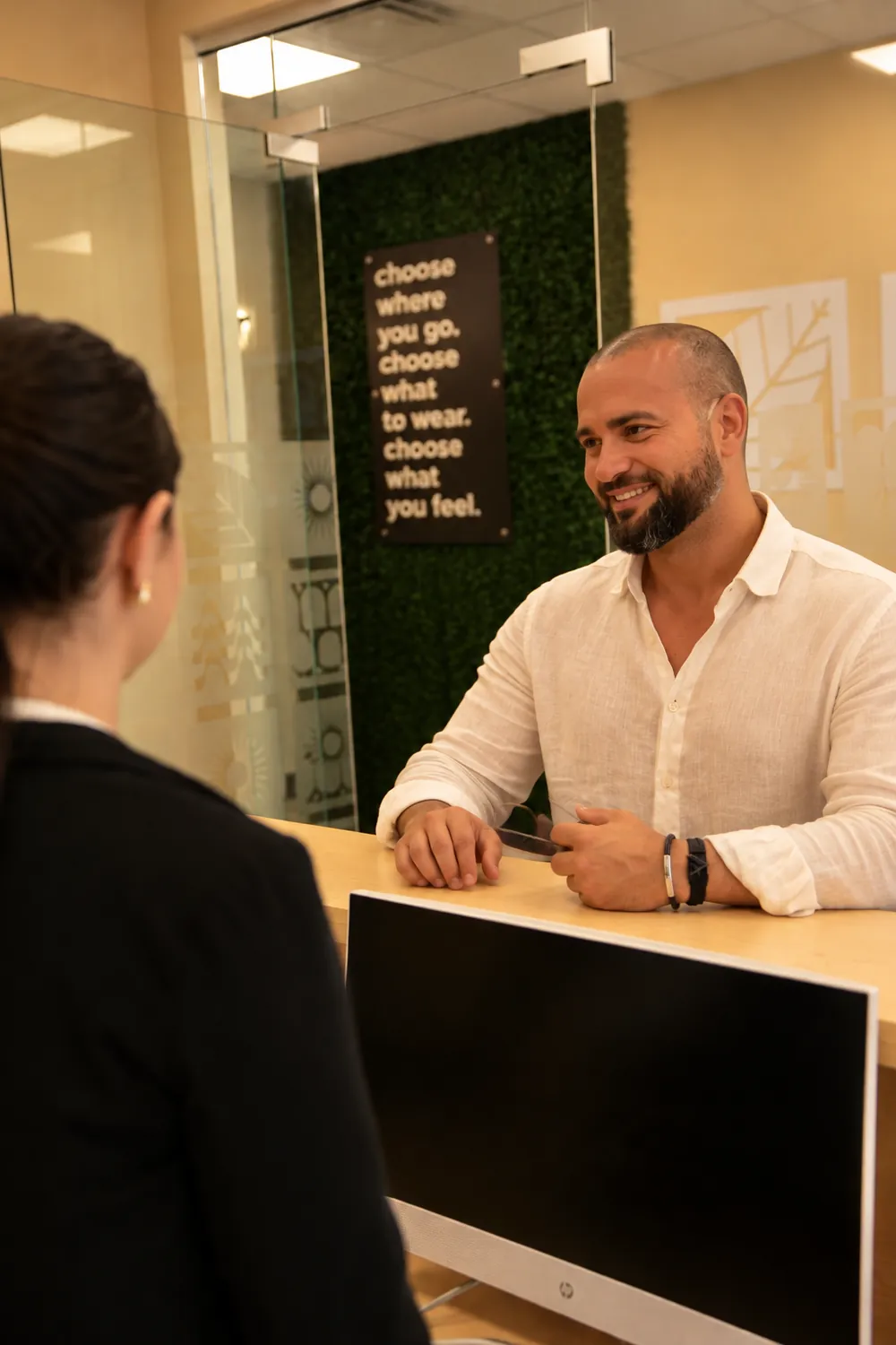 Client at the Riolaser front desk before a laser hair removal consultation for men
